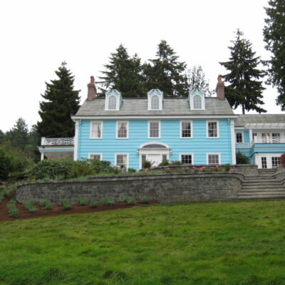 Layers of Roman style pisa retaining wall stones and steps add elegance and grandeur to this Seattle, Washington home.