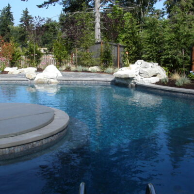 Rock installation around pool for a natural landscape design