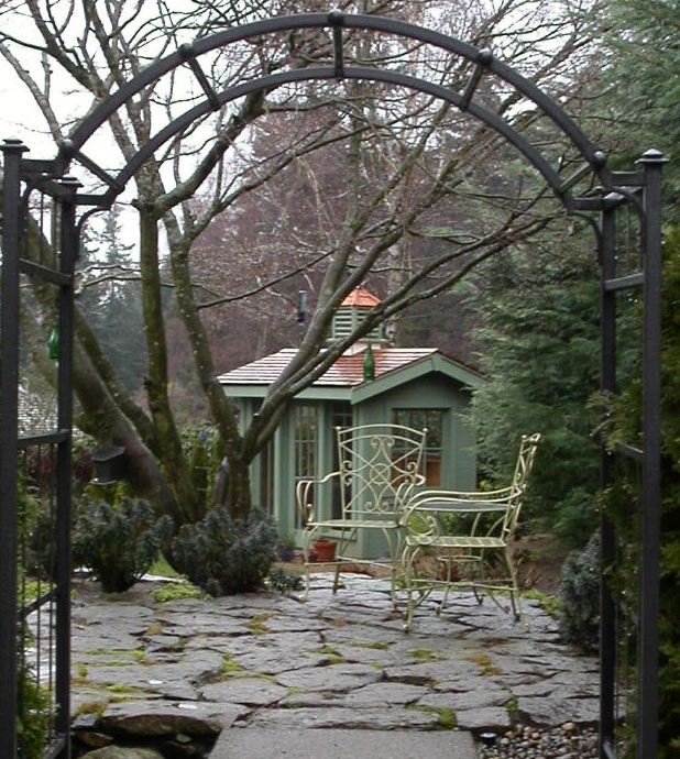 Mission style green garden shed was a custom construction by Bonney Lake Landscapes in Seattle, Washington.