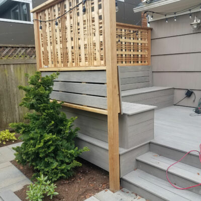 A custom deck is lined with a decorative privacy fence in residential backyard in Seattle.